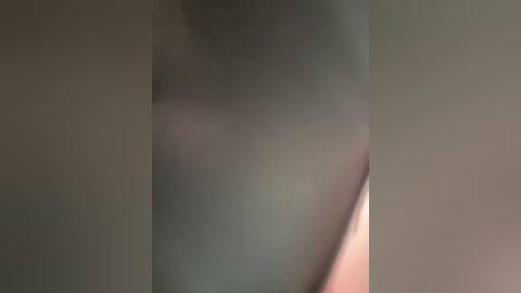 A blurred, intimate video of a partially nude individual, possibly male, with a light skin tone. The focus is on the torso and upper thigh, creating a sense of mystery and eroticism.