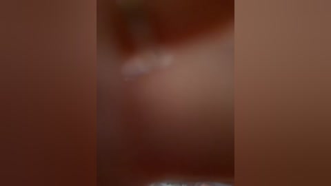 The image is a blurred video featuring two people with light skin tones, possibly engaging in an intimate moment. The background is indistinct, focusing on the figures, making it difficult to discern specific details about their clothing or surroundings.