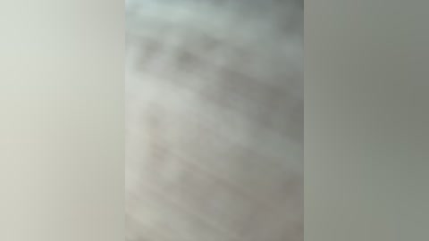 A video of a foggy, abstract scene with indistinct shapes and textures, creating a hazy, dreamlike atmosphere. The colors are muted grays and whites, evoking a sense of mystery and vagueness.