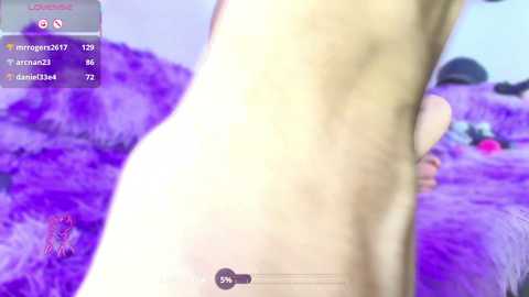 A blurred, low-quality video of a nude person's side profile, standing in a field of purple flowers, with a virtual reality interface overlay showing user statistics.