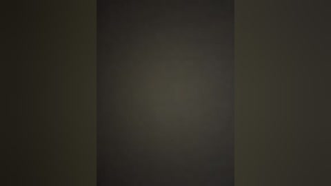 A dark, textured video with a vertical gradient, shifting from deep black to a muted olive green, creating a sense of depth and mystery.